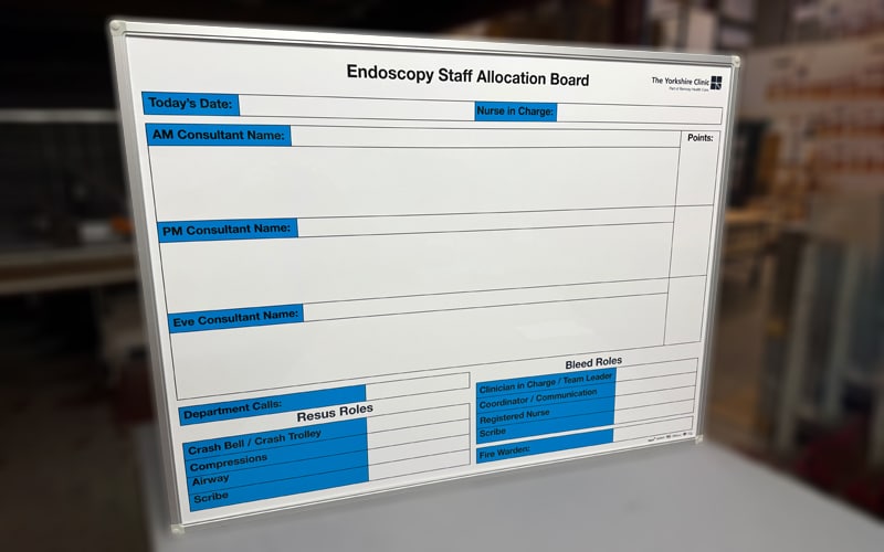 Bespoke endoscopy staff allocation whiteboard with blue headings and aluminium frame